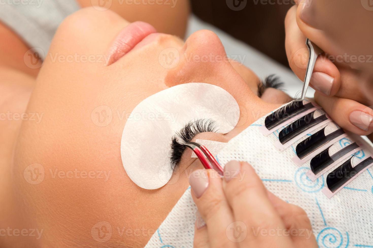 Procedure of eyelashes extension in beauty salon photo