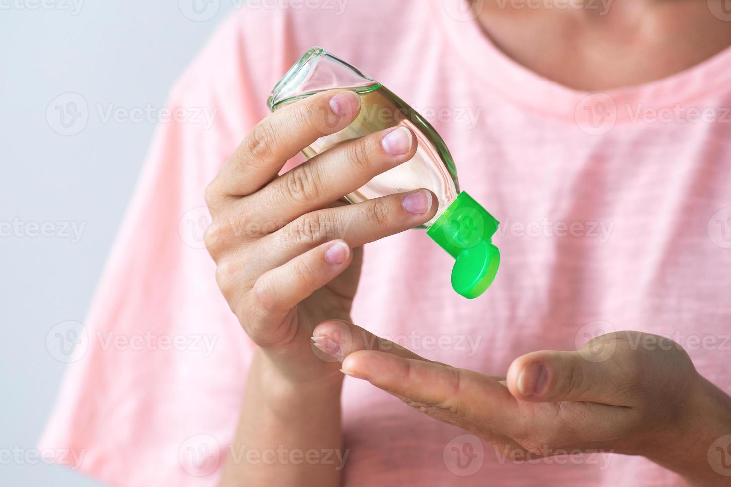 Woman with a small bottle of hand sanitizer photo