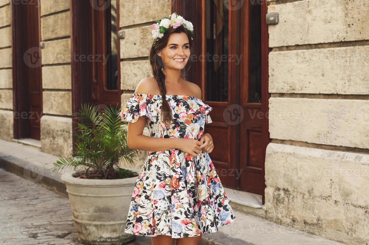 Happy woman in beautiful dress on the street photo