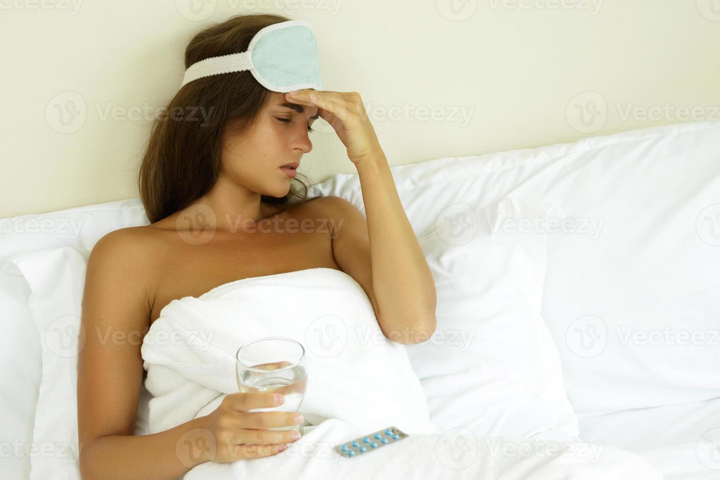 Woman in bedroom want to drink sleeping pills photo
