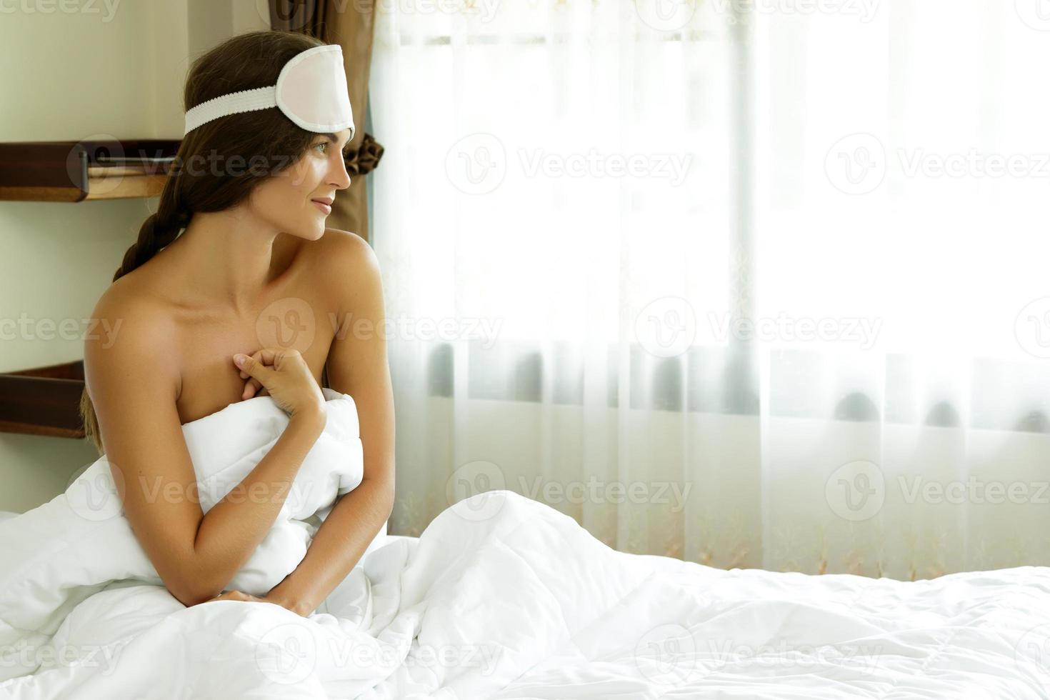 Happy woman waking up after good sleeping photo