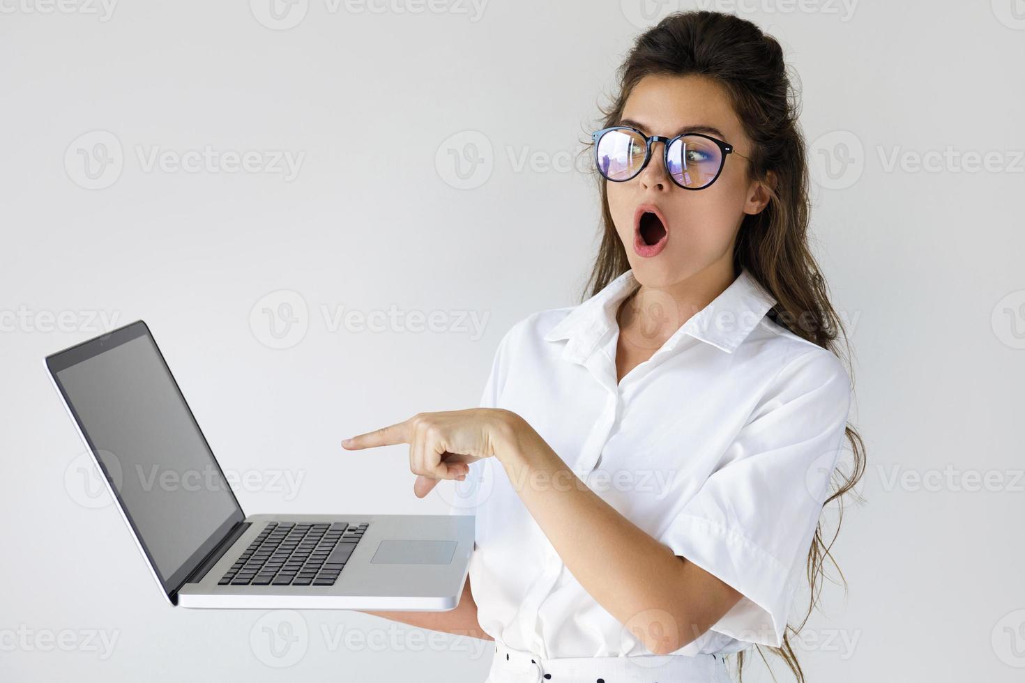 Young businesswoman with a laptop computer in her hands photo