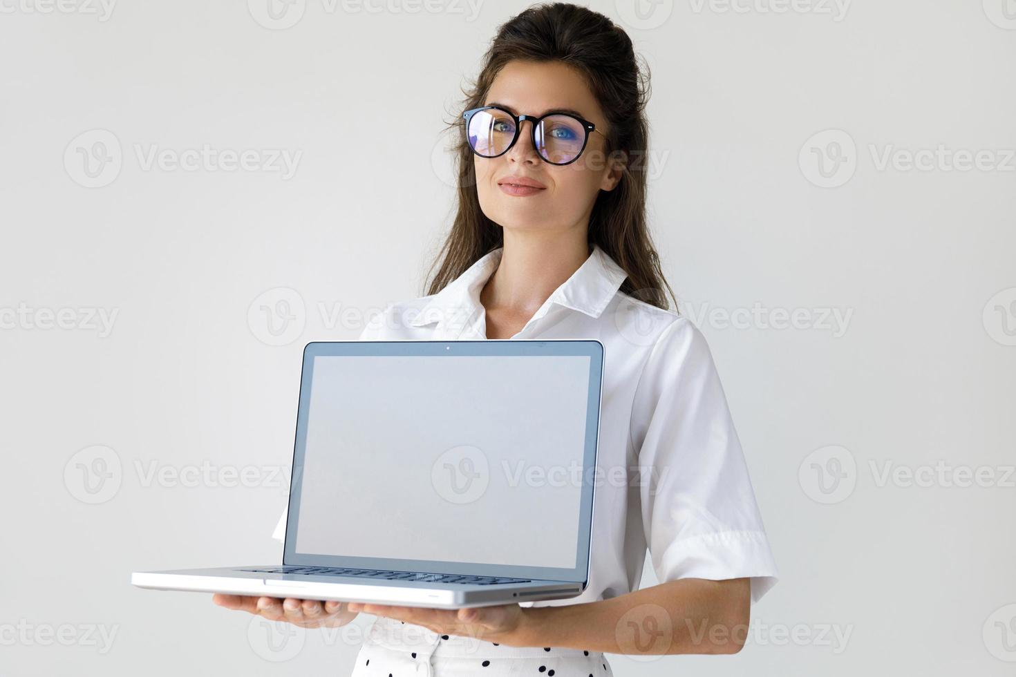 Young businesswoman with a laptop computer in her hands photo