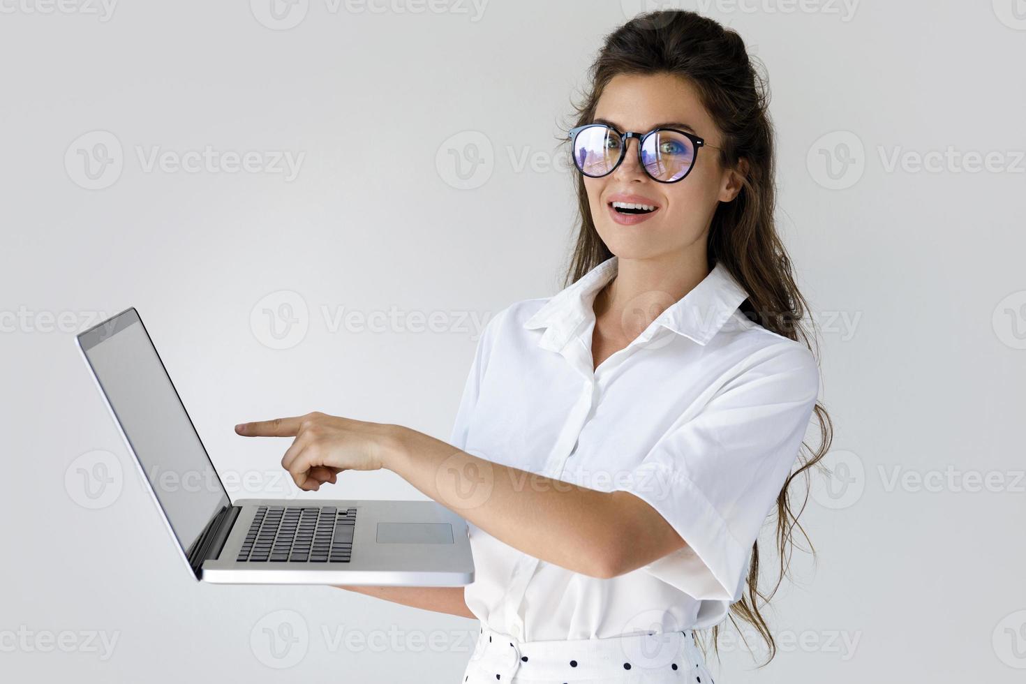 Young businesswoman with a laptop computer in her hands photo