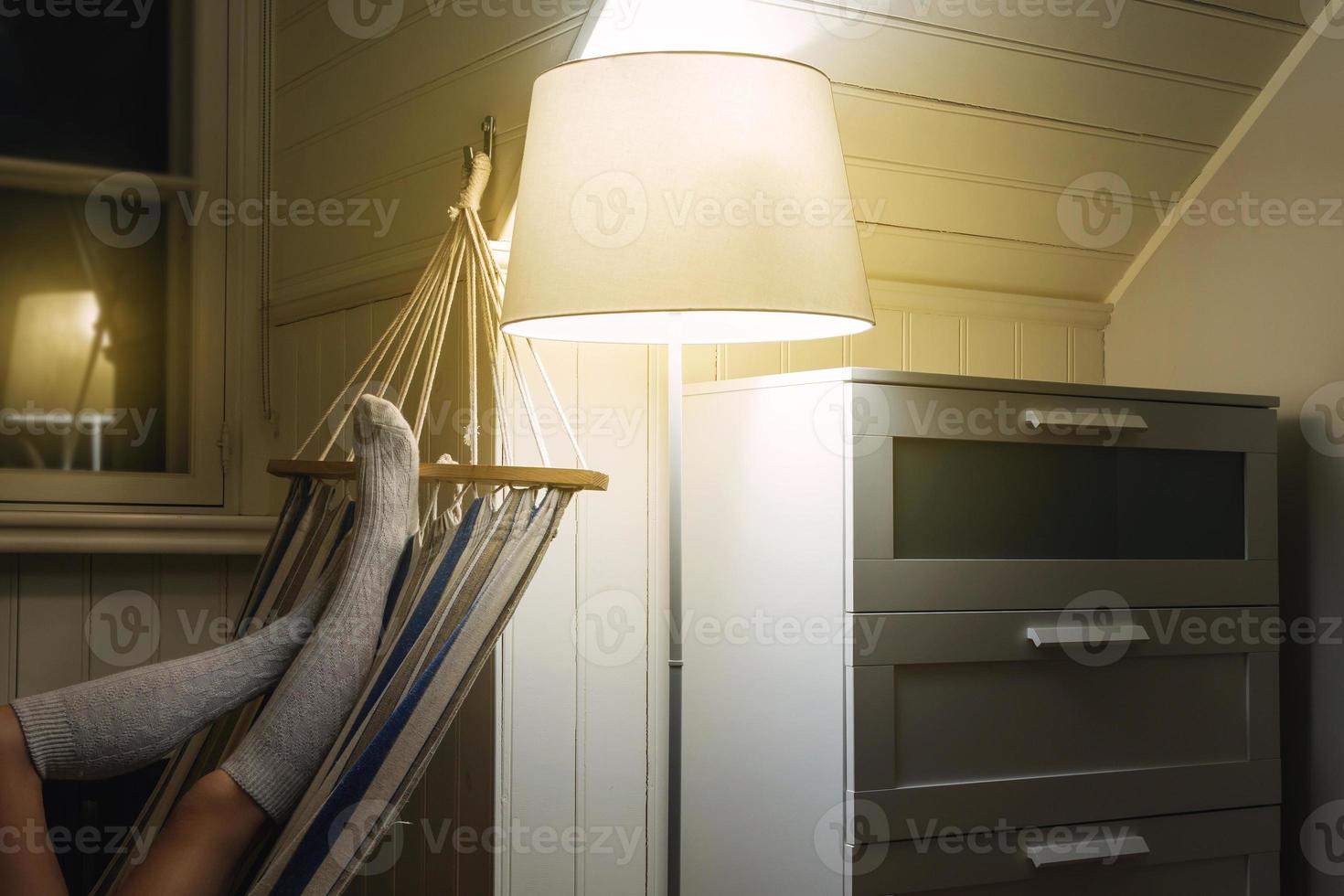 Woman wearing woolen stockings lying in the hammock photo