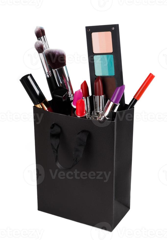 Different makeup objects in the shopping bag photo