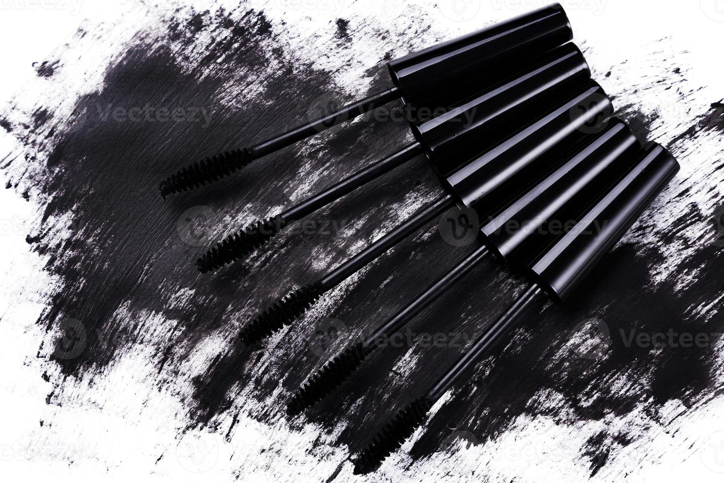 Close up of black brushes and smudged mascara photo