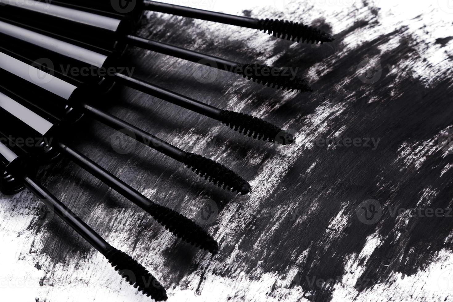 Close up of black brushes and smudged mascara photo