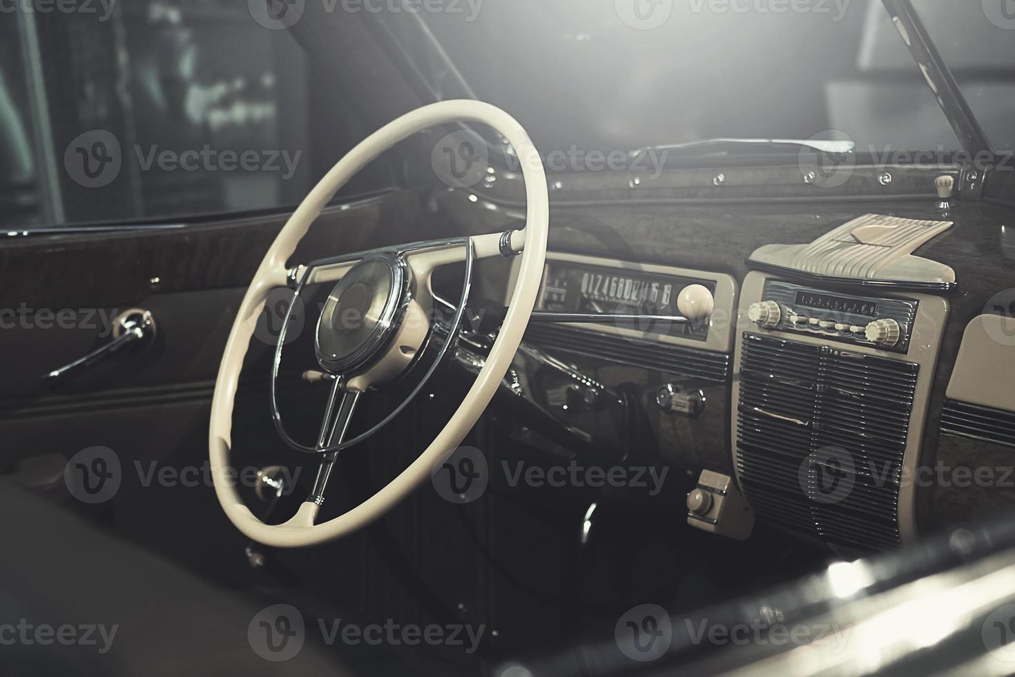 Steering wheel and part of interior of the retro photo