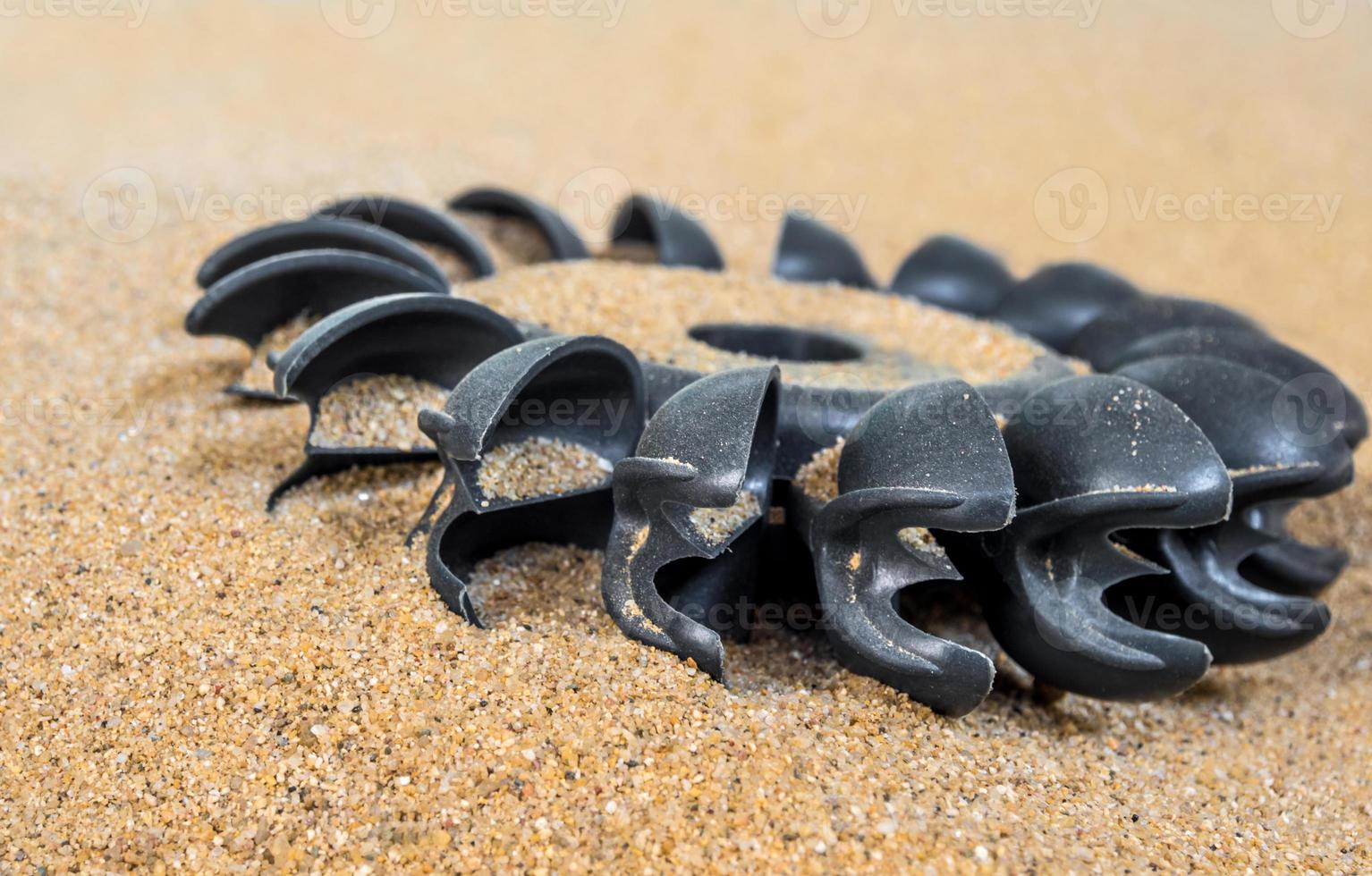 Plastic Pelton water turbine on sand with out water photo