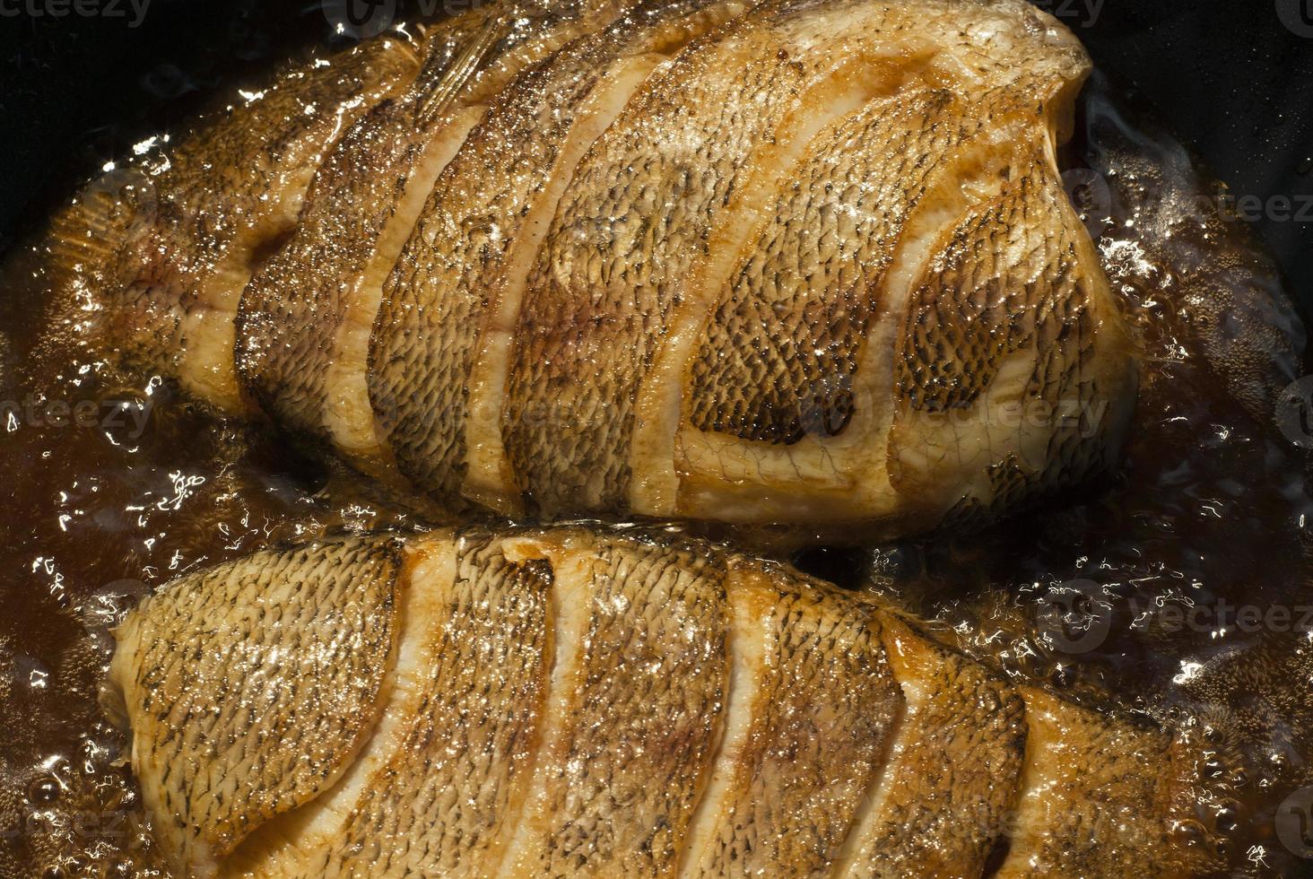 Sun-dried snakeskin gourami, fried in a pan photo