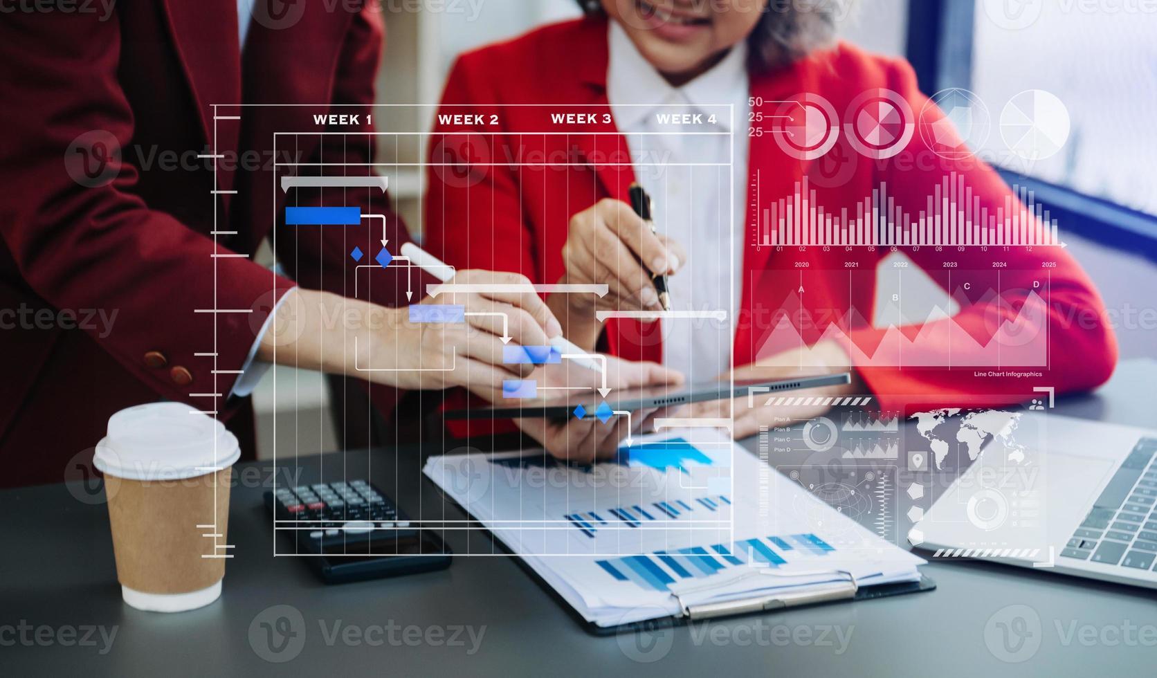 Businessman hand Project manager working and update tasks and Gantt chart scheduling virtual diagram.with smart phone, tablet and laptop photo