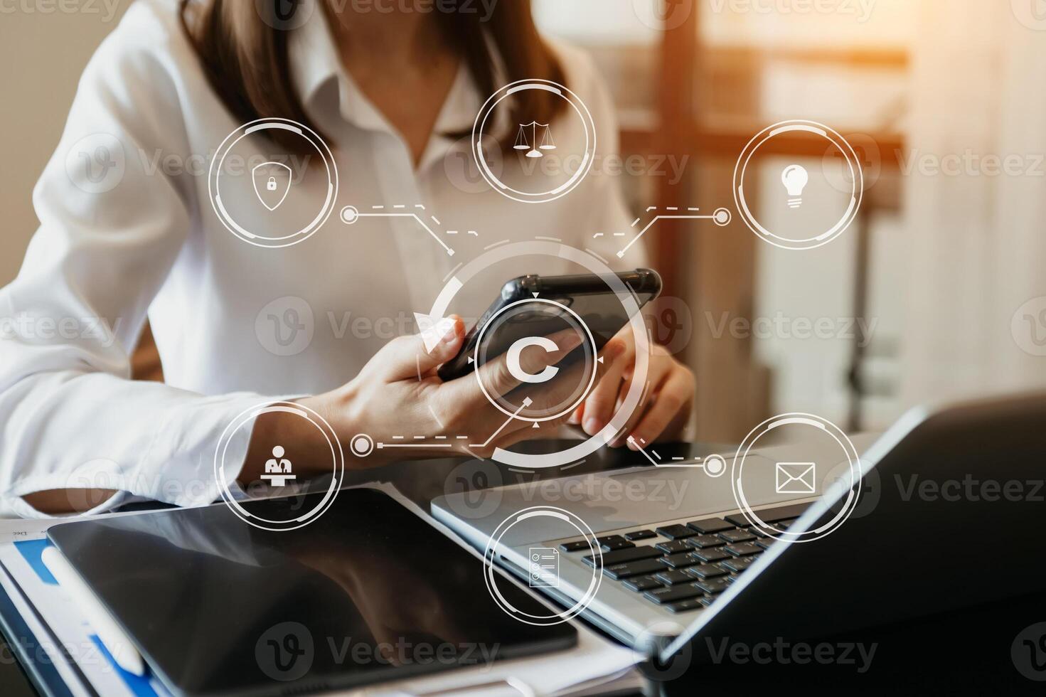 Copyright or patent concept, Person hand using laptop computer, tablet and smartphone with virtual screen copyright icon trademark, Creation ownership against piracy. photo