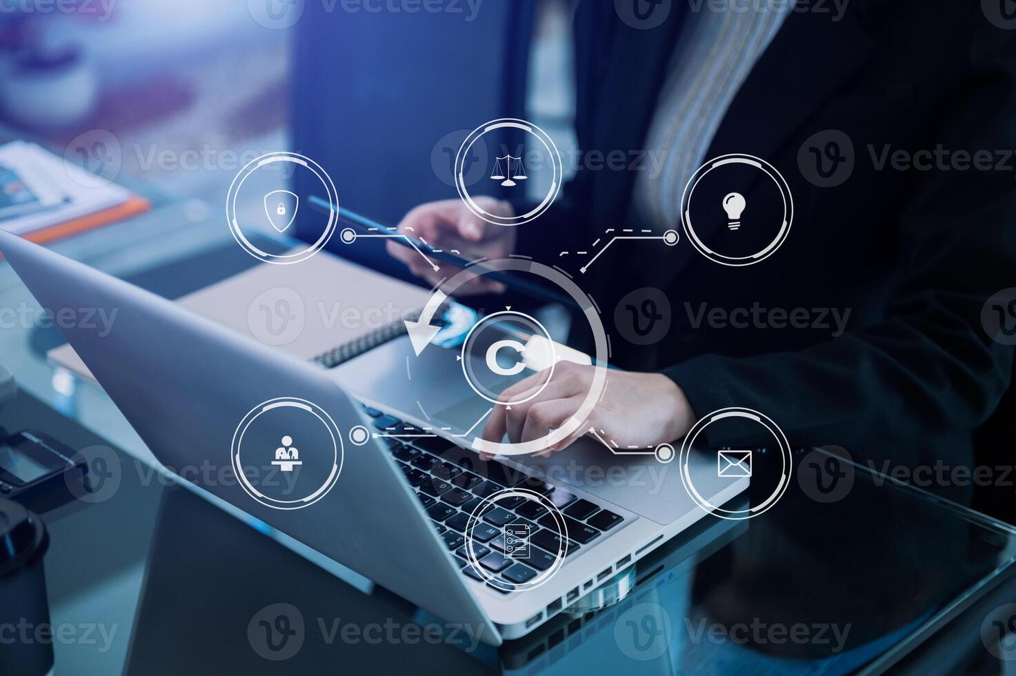 Copyright or patent concept, Person hand using laptop computer, tablet and smartphone with virtual screen copyright icon trademark, Creation ownership against piracy. photo