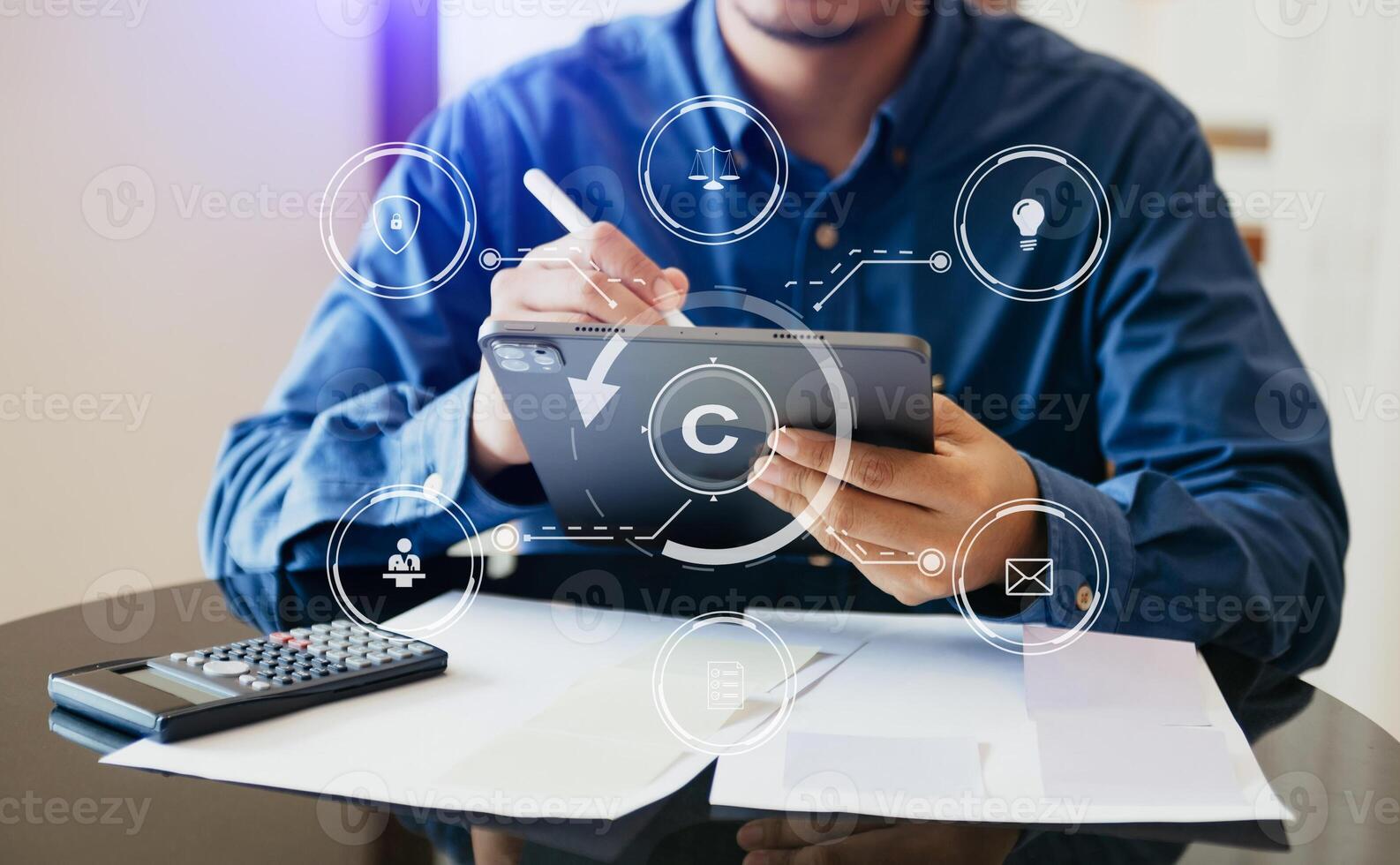 Copyright or patent concept, Person hand using laptop computer, tablet and smartphone with virtual screen copyright icon trademark, Creation ownership against piracy. photo