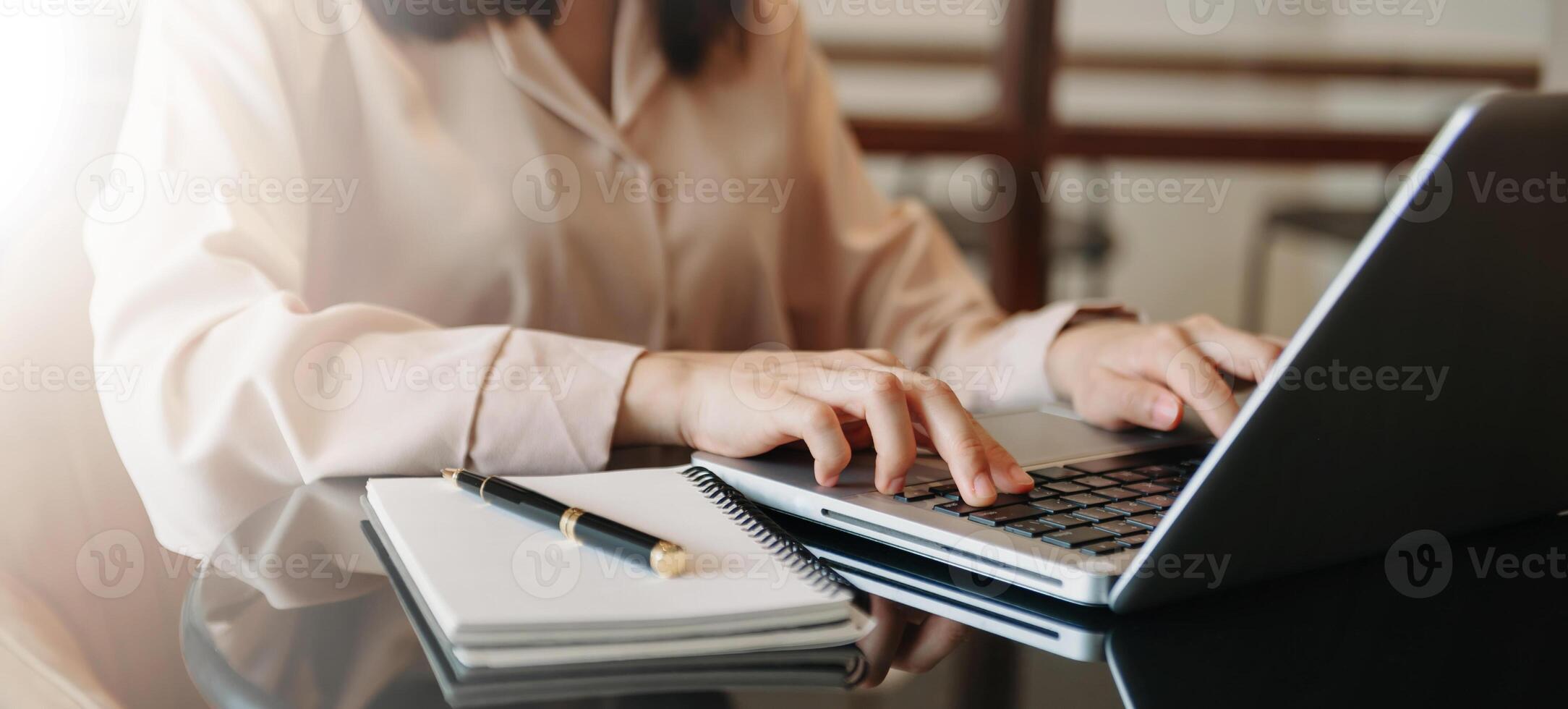business documents on office table with smart phone and digital tablet and graph financial and woman working at office photo