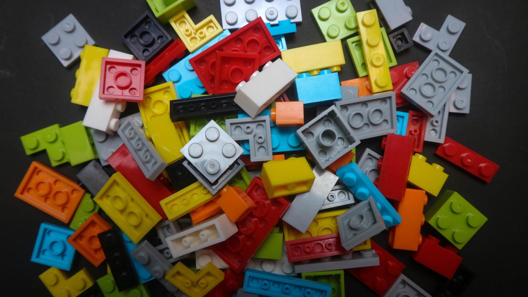 Plastic toy block on a black background photo