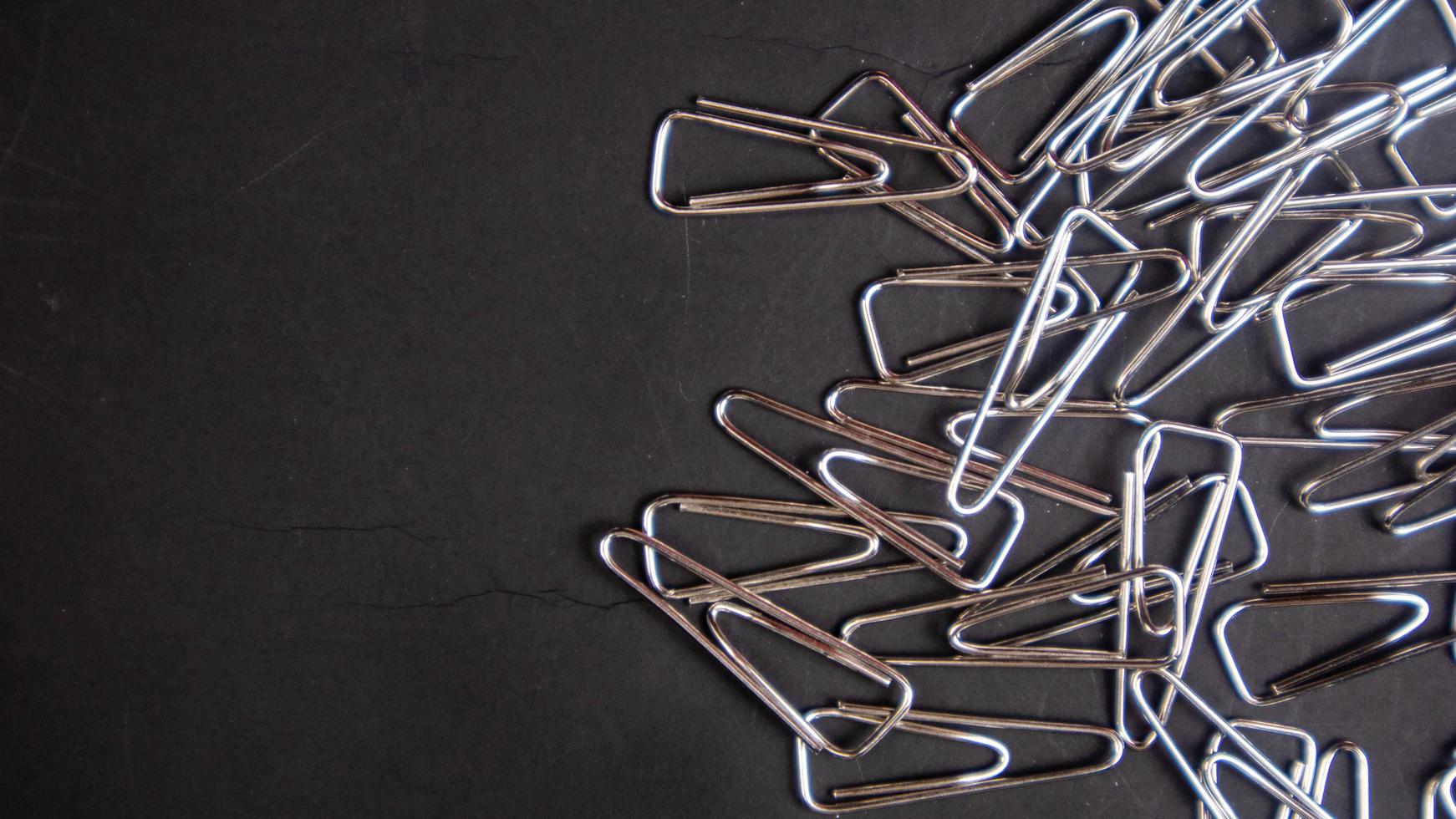 a paper clip on a black background photo