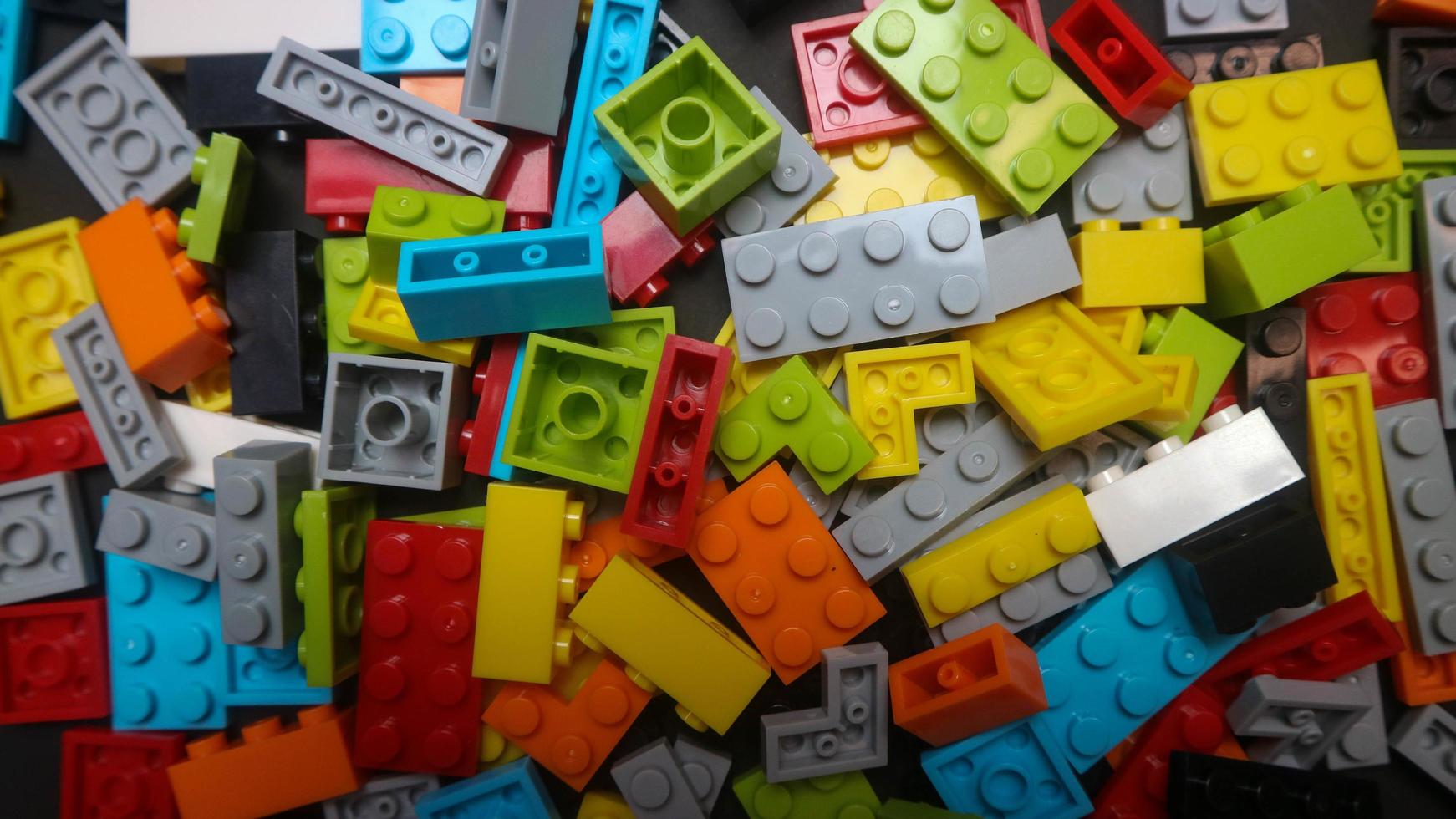Plastic toy block on a black background photo