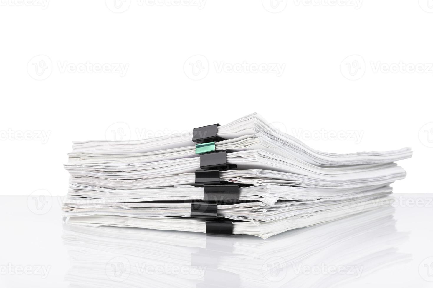 A stack of papers in the office on a white table, White isolated background. photo