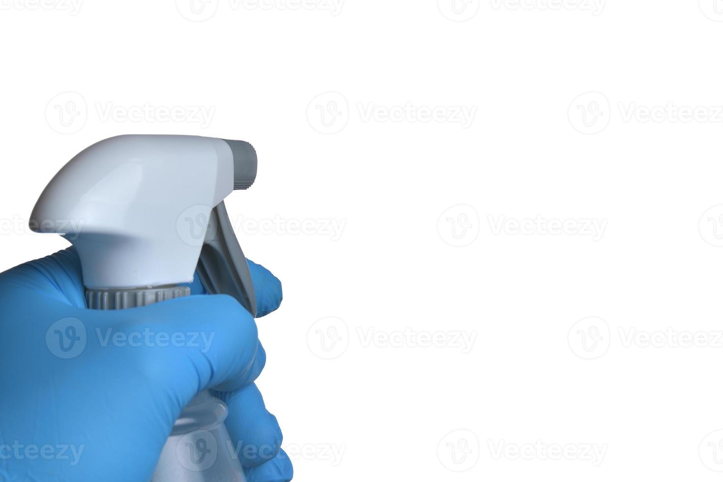 Disinfection bottle in hand with blue glove isolated on white background photo