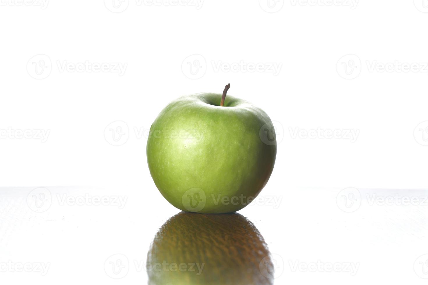 Green apple on wooden table with white background photo