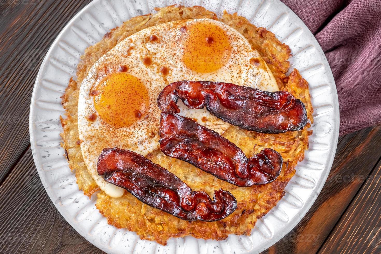 Hash brown with egg and bacon photo