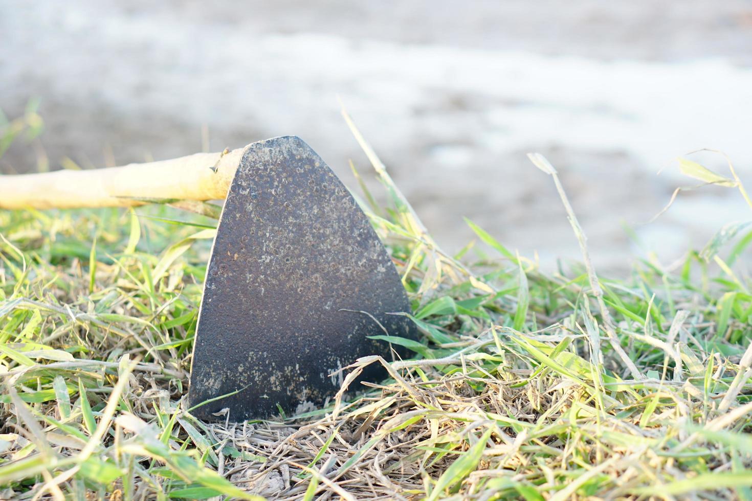 Hoe digging soil on the path in the field photo