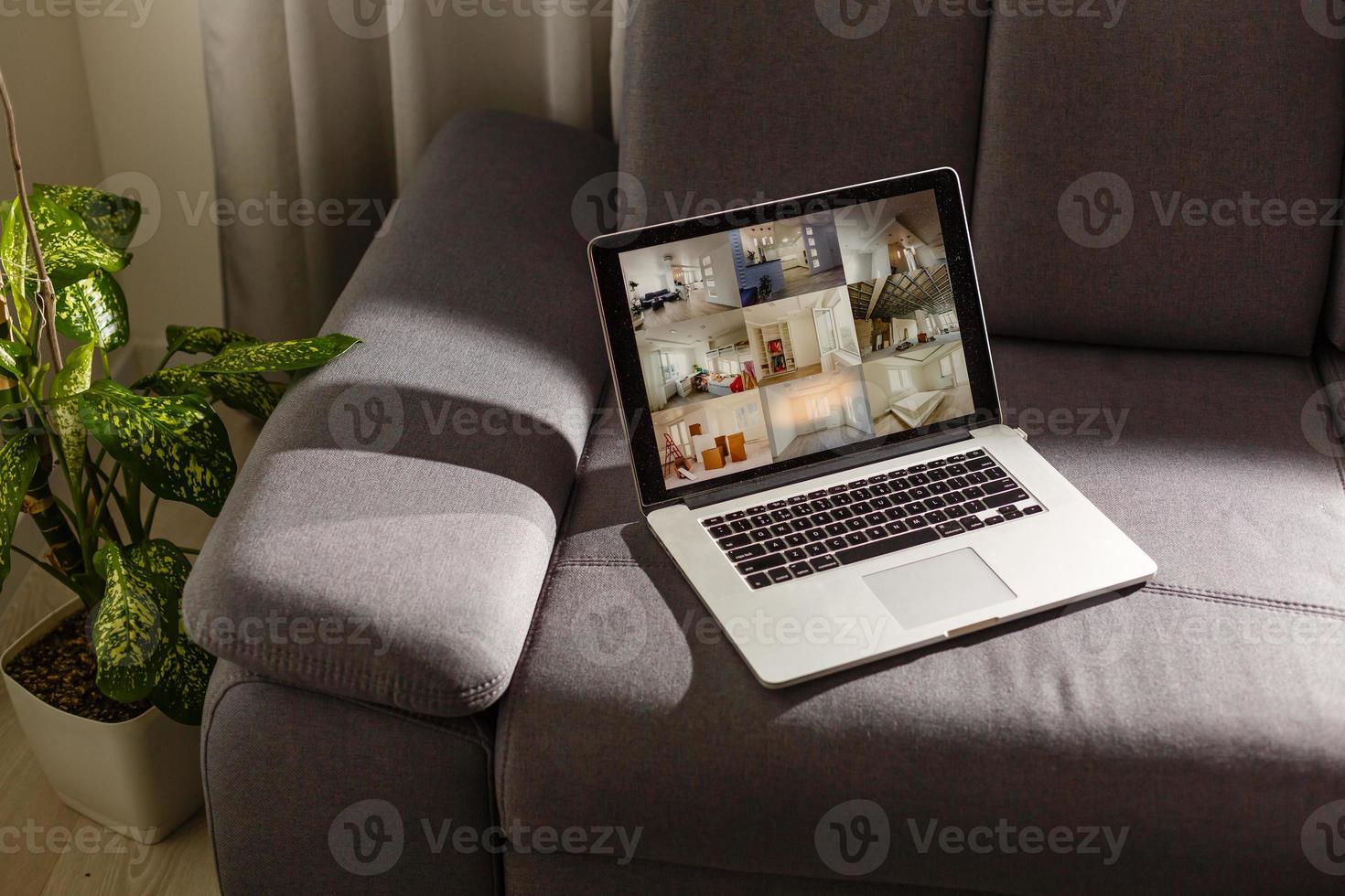 Laptop with news website in screen on table in business office, corporate lounge or hotel lobby. Company wireless wifi. Modern cafe or workplace. Online article in computer. Woman on chair waiting.. photo