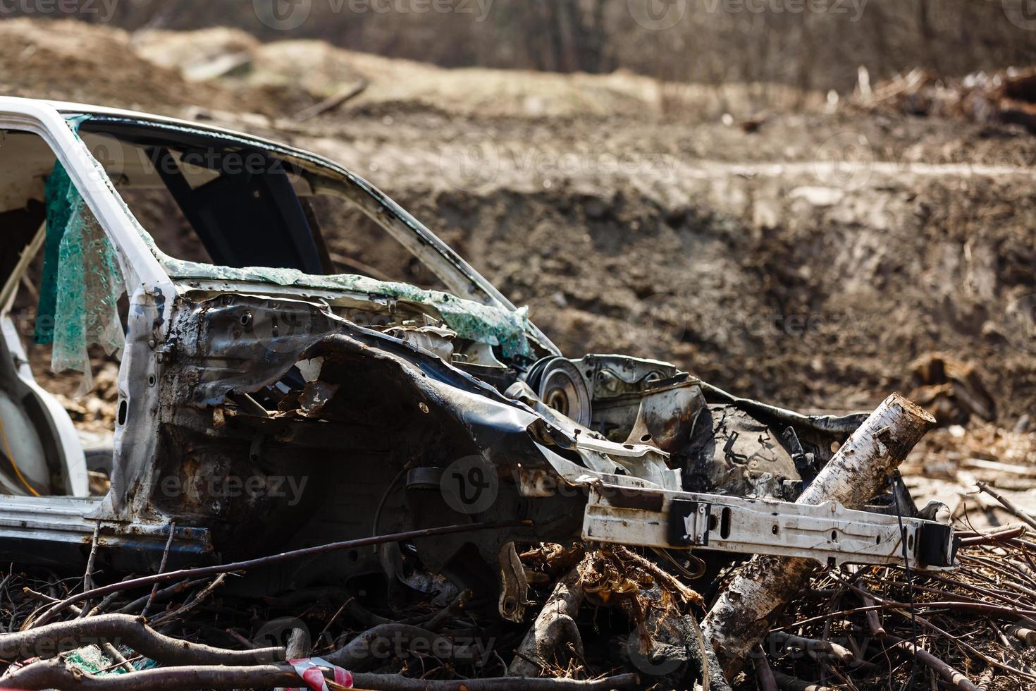 Broken car in a dump in the field photo