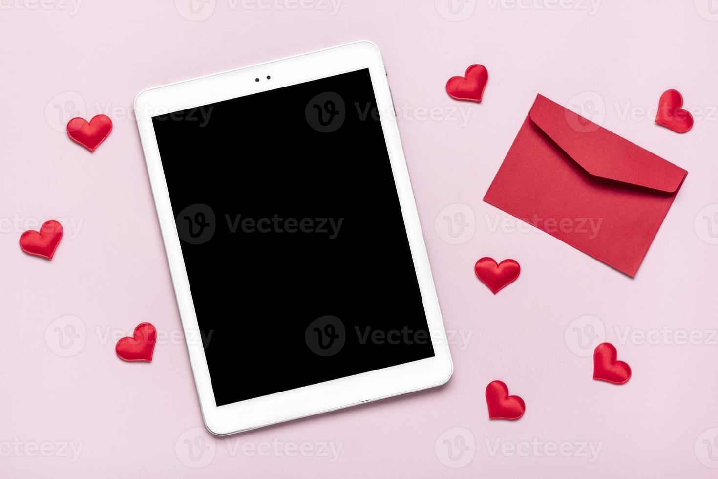 digital tablet for chooses gifts, makes purchase, envelope, red hearts on pink table Top view Flat lay Holiday shopping list, Happy Valentine's day, party, online shop concept Mock up photo