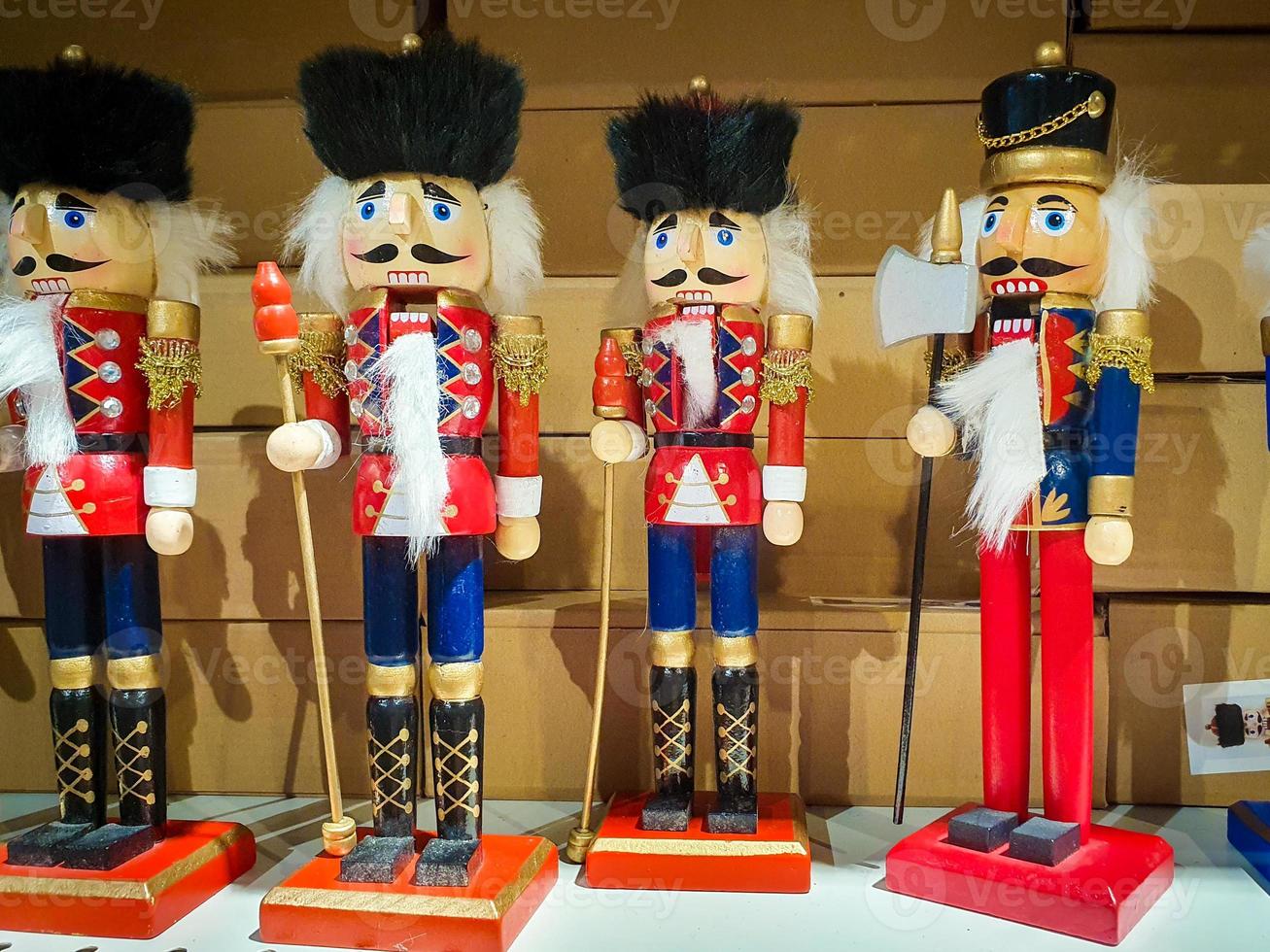 Several different nutcraker soldiers toys displayed in a store, christmas decoration for sale in market Happy New Year photo