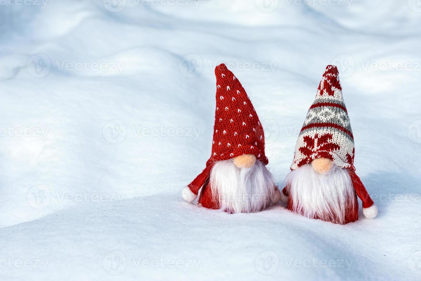 tarjeta navideña lindos gnomos escandinavos con sombrero rojo y barba blanca en un banco de invierno cubierto de nieve cuento de hadas nevadas invierno hola diciembre, enero, concepto de febrero feliz año nuevo, navidad foto