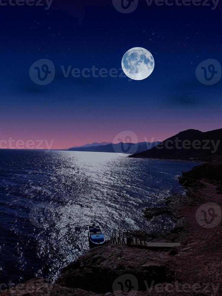 full moon on red sea and mountains photo