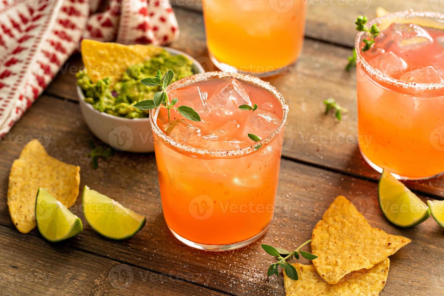 Spicy grapefruit margarita with chips and guacamole photo