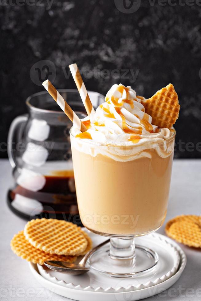 Caramel coffee latte in a dessert glass photo