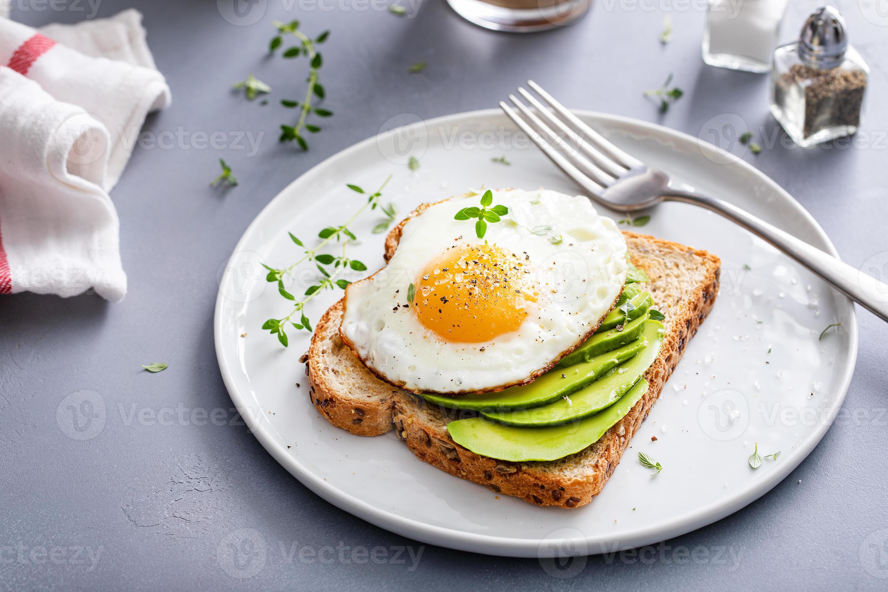 Avocado toast on a toasted multigrain bread with a fried egg 16212043