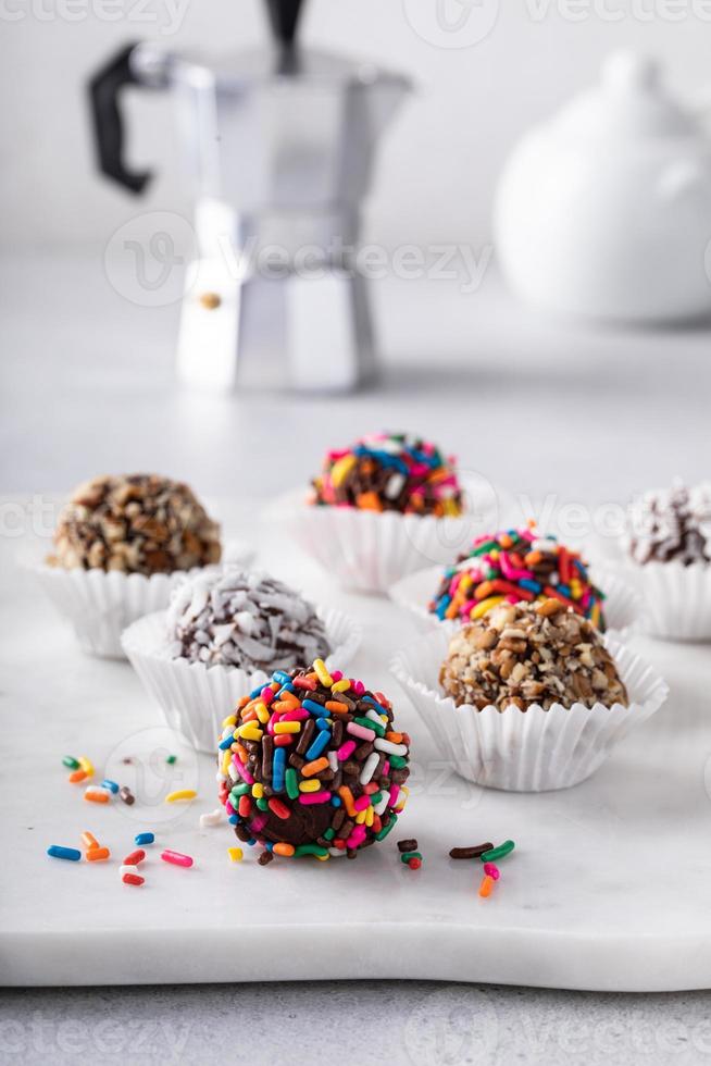 Homemade chocolate truffles covered with sprinkles and nuts photo