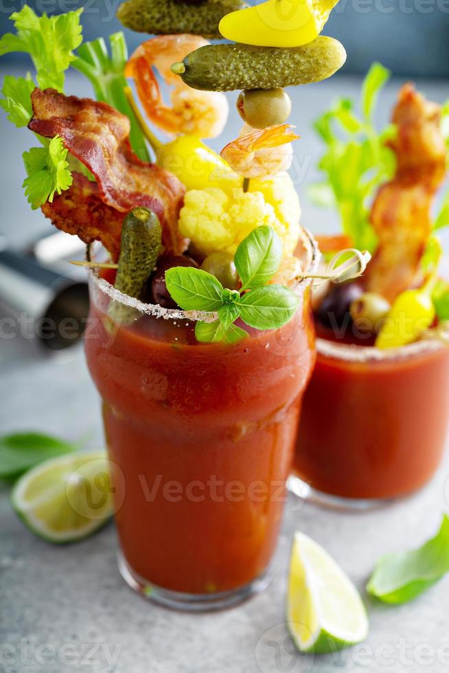 Bloody mary cocktail topped with various garnishes photo