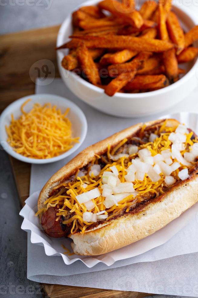 Chili hot dog topped with cheese photo