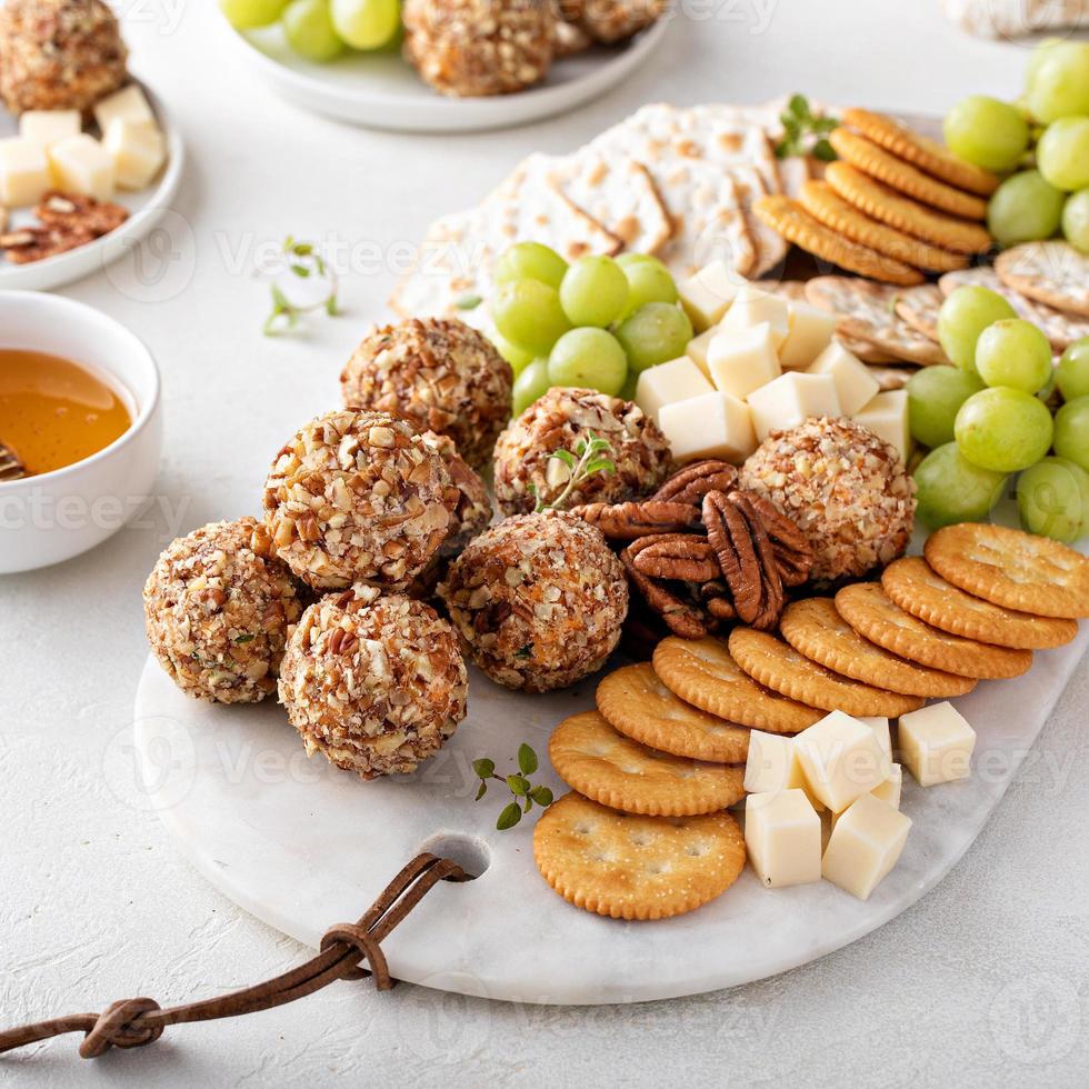 Cheese balls or truffles on a cheese board with crackers photo