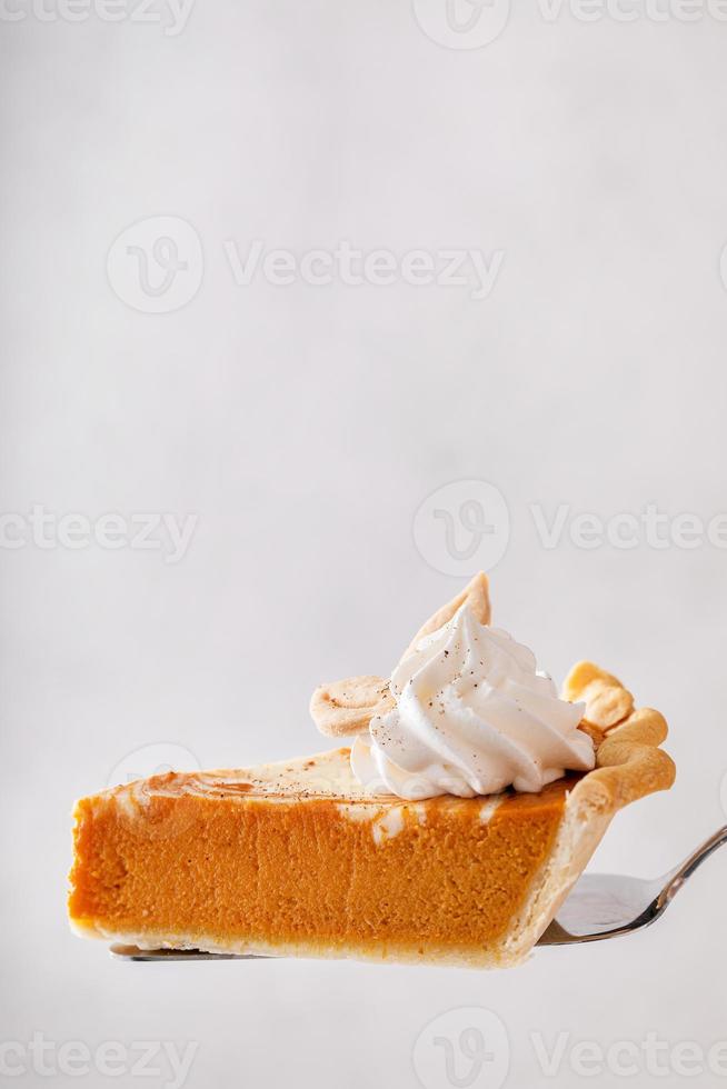 Pumpkin cheesecake swirl pie topped with whipped cream photo