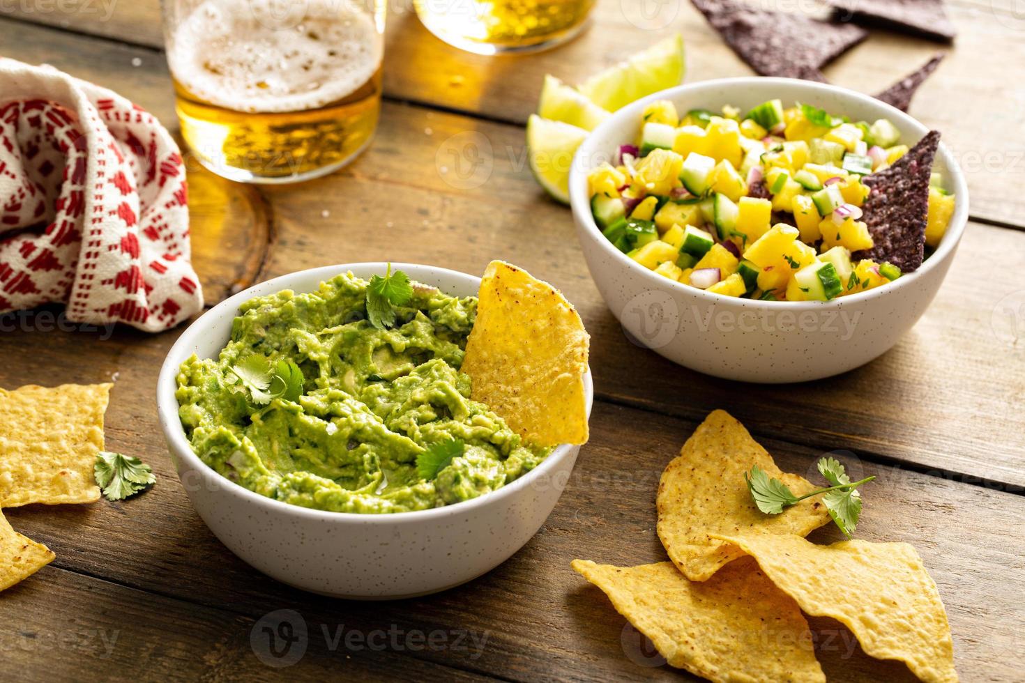Tortilla chips with dips, guacamole and salsa photo