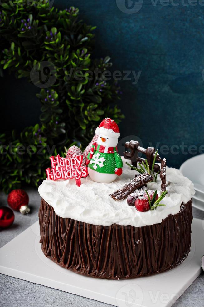 Chocolate Christmas celebration cake with holiday decorations photo