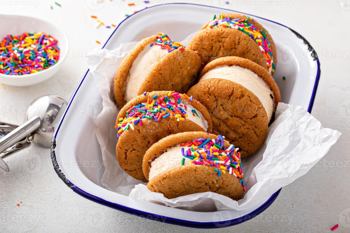 Ice cream and cookies sandwiches stacked on the table photo