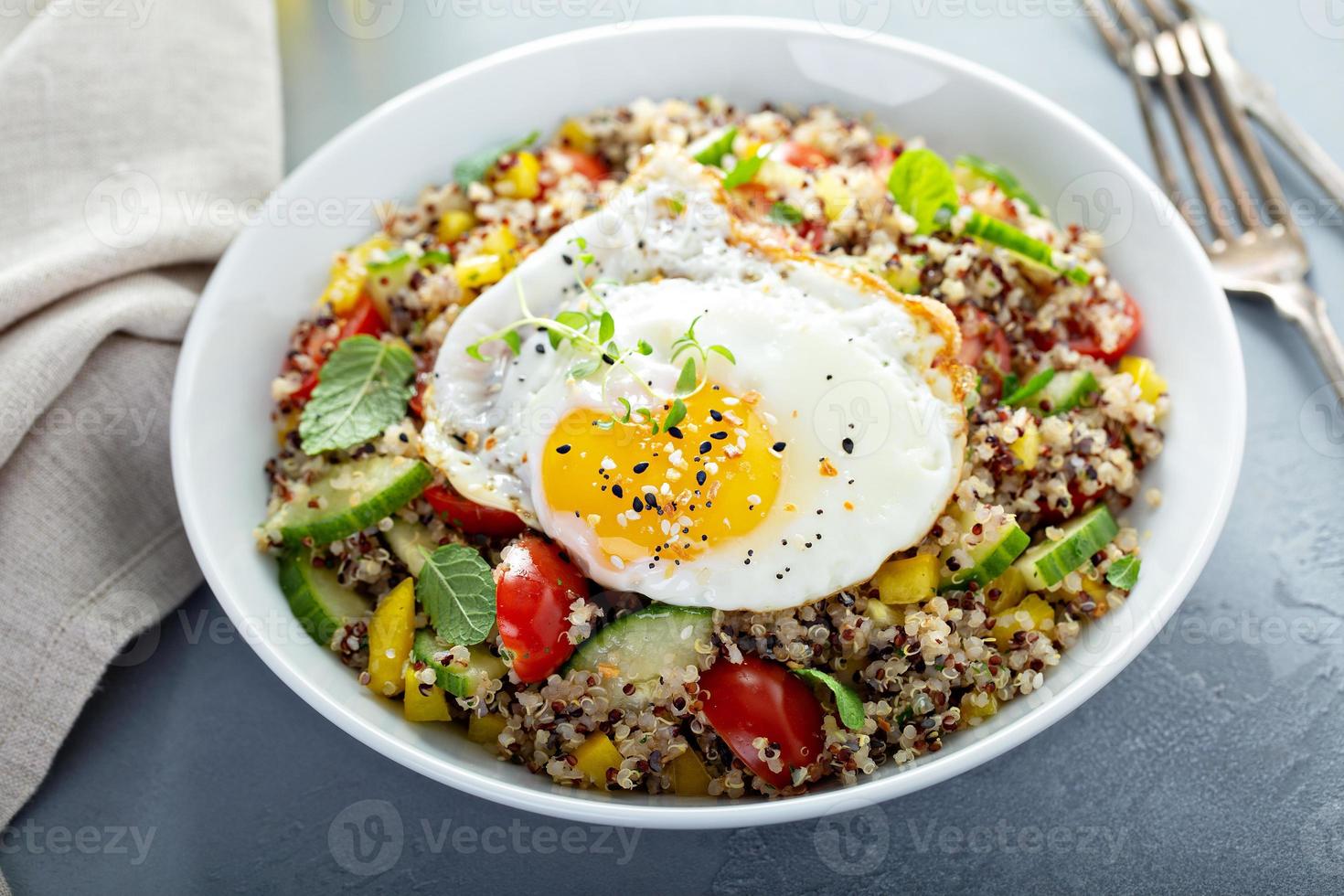 Fresh quinoa tabbouleh salad with fried egg photo