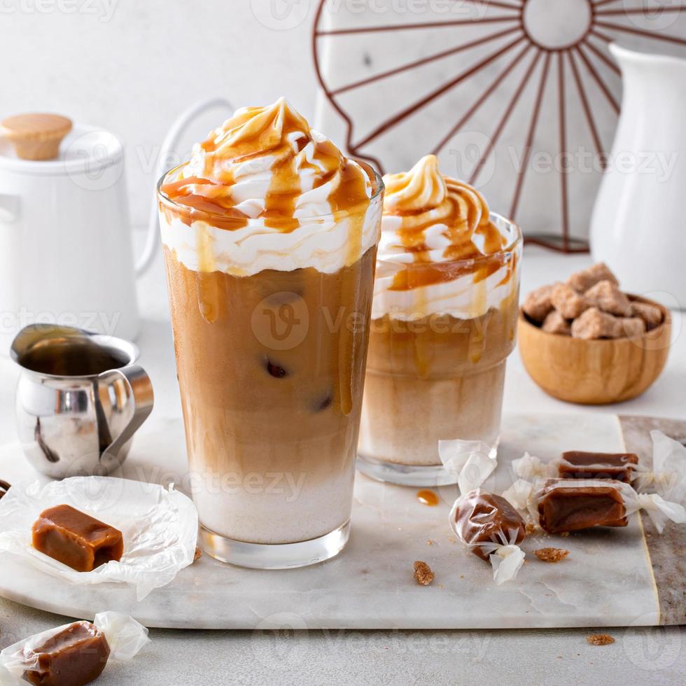 Iced caramel latte topped with whipped cream and caramel sauce photo