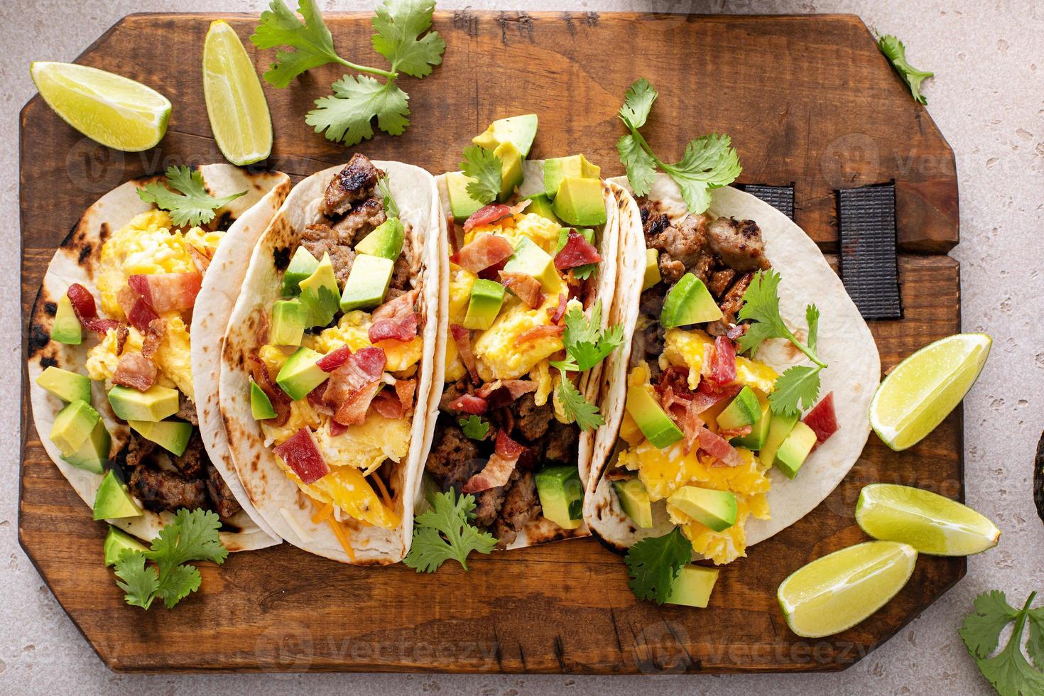 Breakfast tacos with sausage, eggs, bacon and avocado photo