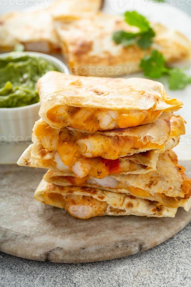 Shrimp and cheese quesadillas served with guacamole photo