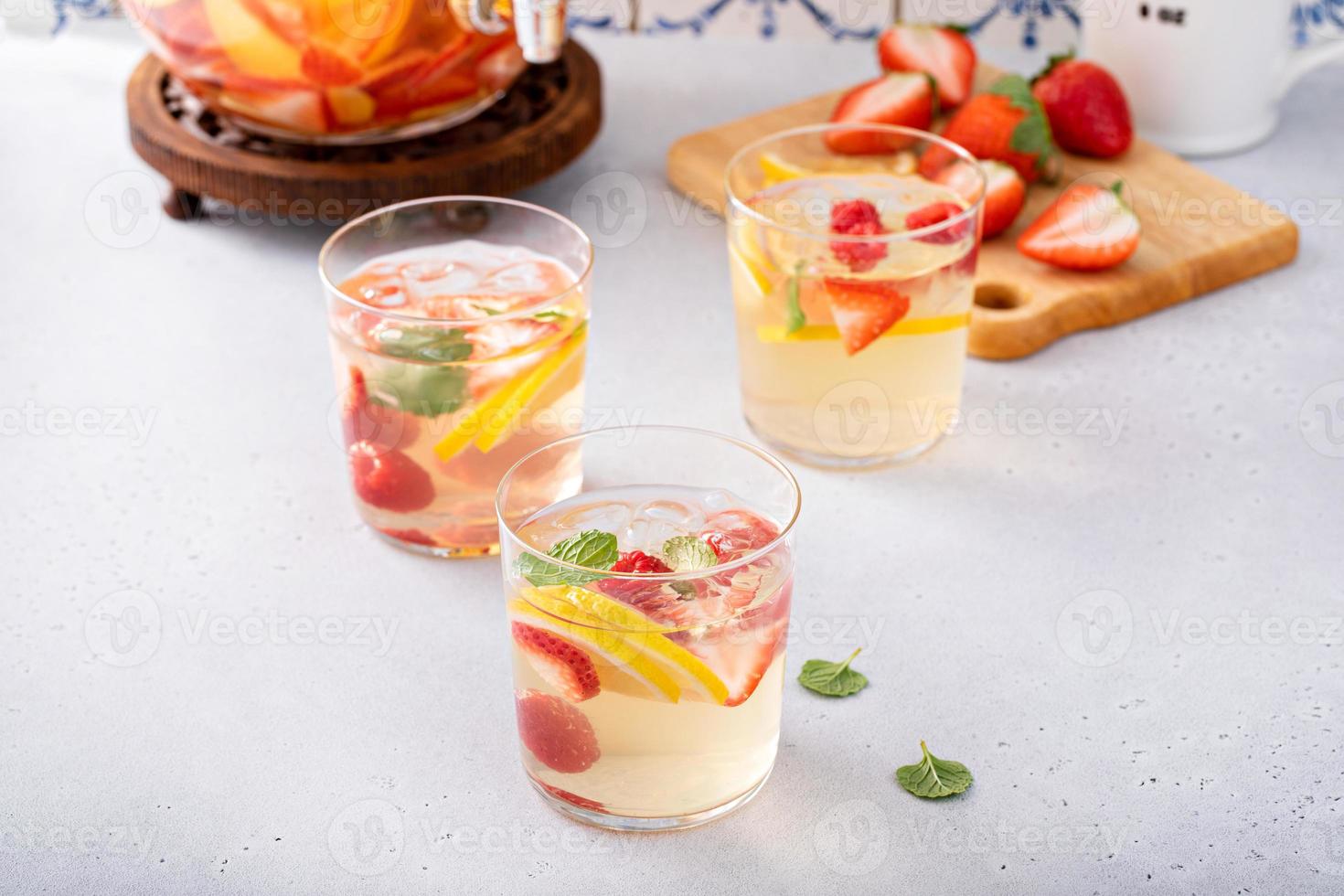 Summer sangria punch in a pitcher and glasses photo